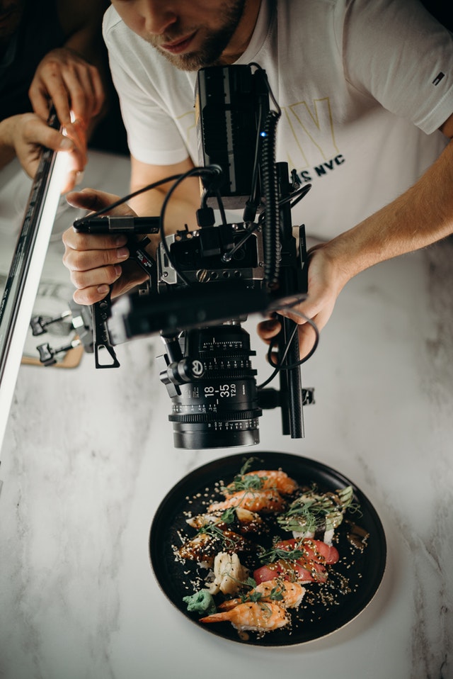 man-using-video-camera-pointing-on-food-on-plate-3298603.jpg